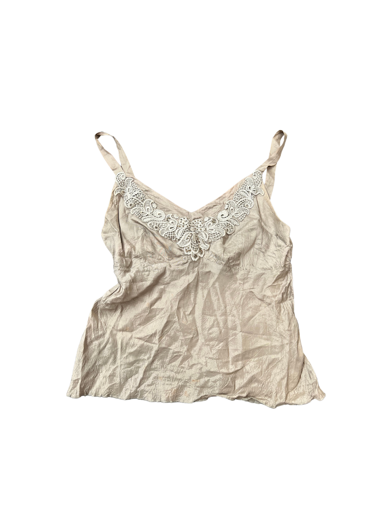 A taupe crushed silk cami with white lace detailing at the neckline and sleeveless design