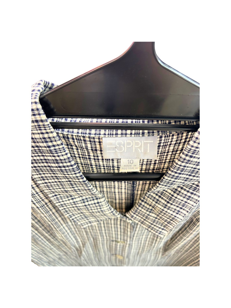 A closeup view of the brand label of  Esprit Vintage Gingham Maxi Dress in black and white with white shell buttons