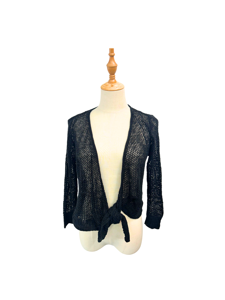 front view of a black Crochet Tie Cardigan from the brand Hooked Up on a mannequin
