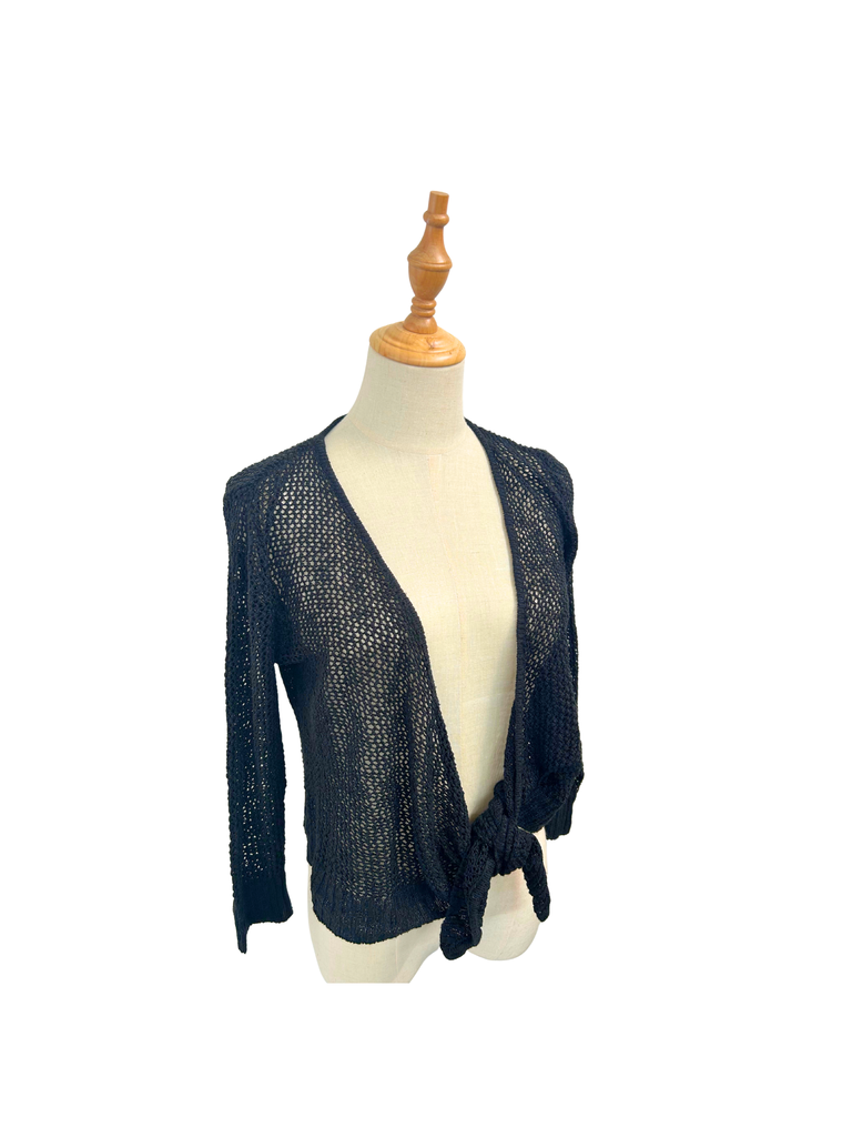side view of a black Crochet Tie Cardigan from the brand Hooked Up on a mannequin
