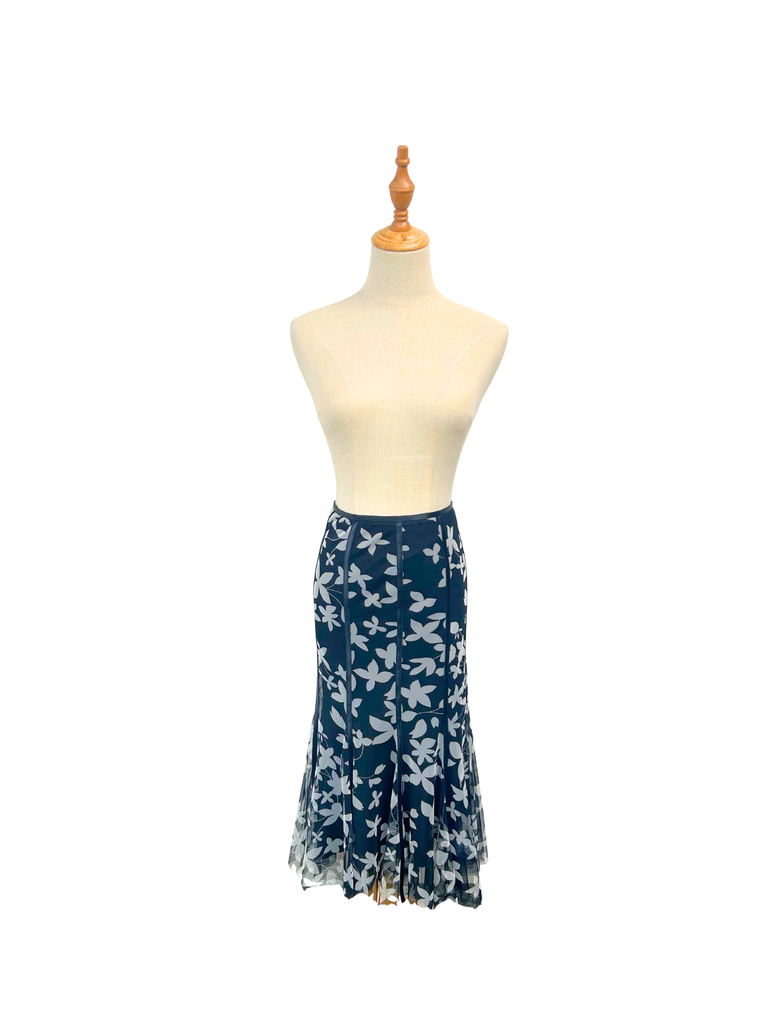 Navy blue floral skirt in a mermaid style cut on a mannequin against a white background