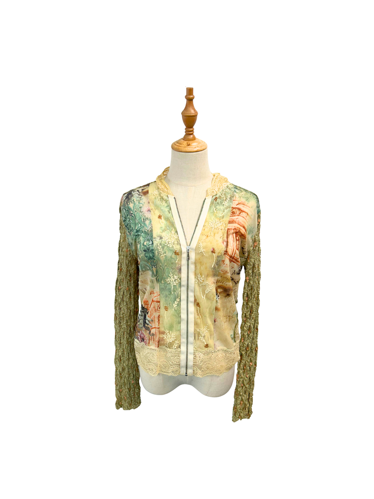A frontal view of a long sleeve printed lace women's shirt that is in green, blue and neutral shades and has a zipper