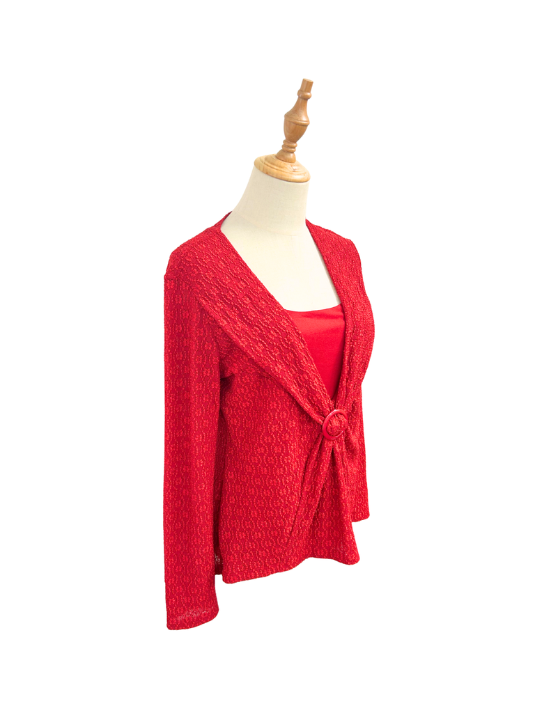 Side view of a STAX Vintage Long Sleeve Top in scarlet red that's made out of all over embroidered fabric and a gathered buckle detail in front
