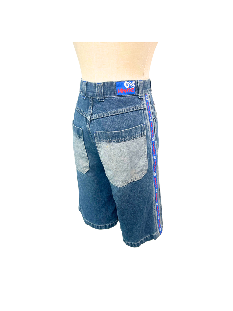 Back view of a pair of vintage blue denim Mango Jorts showing brand label and red, white and blue stripes on each side 
