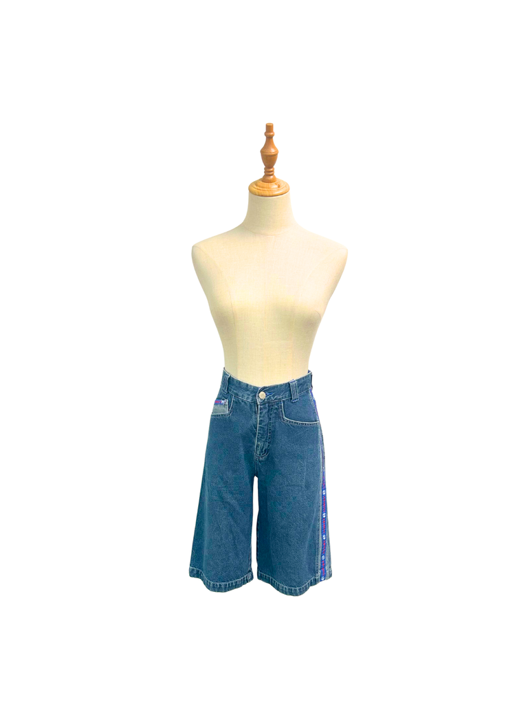 Frontal view of a pair of vintage blue denim Mango Jorts with red, white and blue stripes on each side