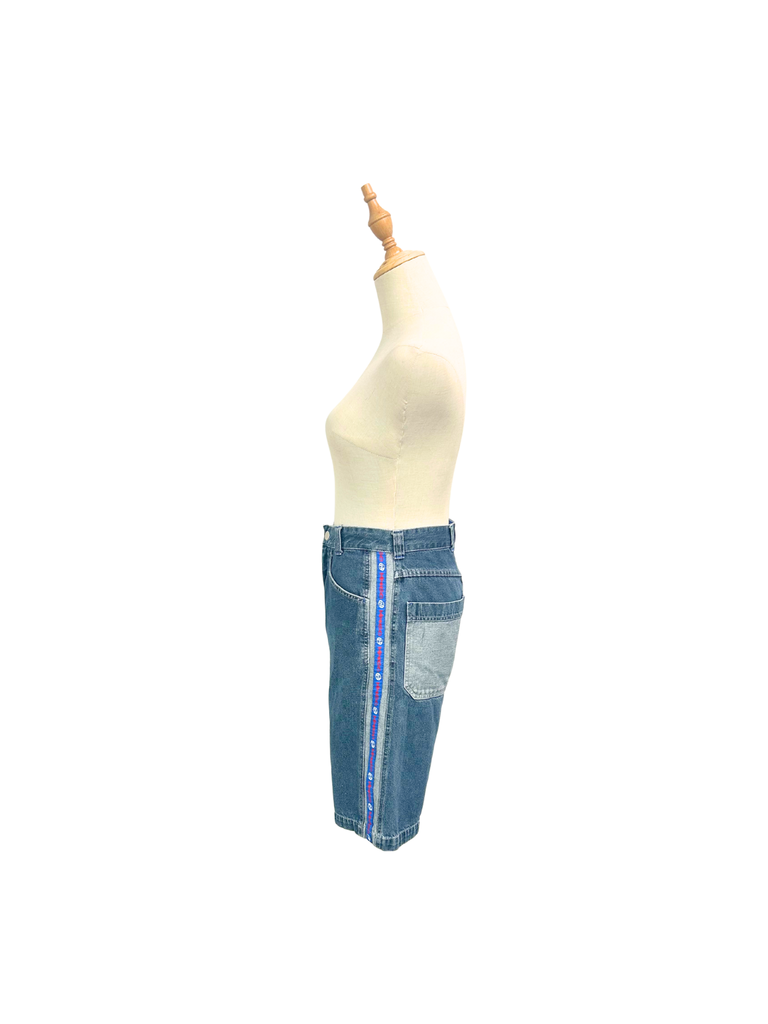 Side view of a pair of vintage blue denim Mango Jorts with red, white and blue stripes on each side