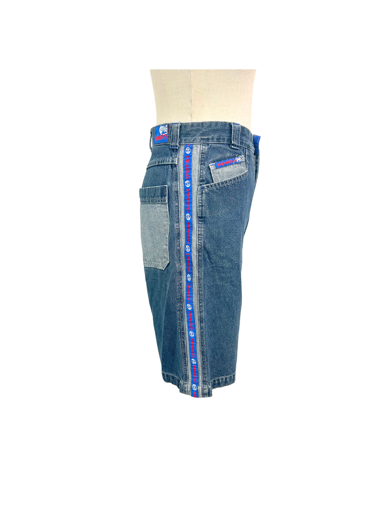 Side view of a pair of vintage blue denim Mango Jorts with red, white and blue stripes on each side 