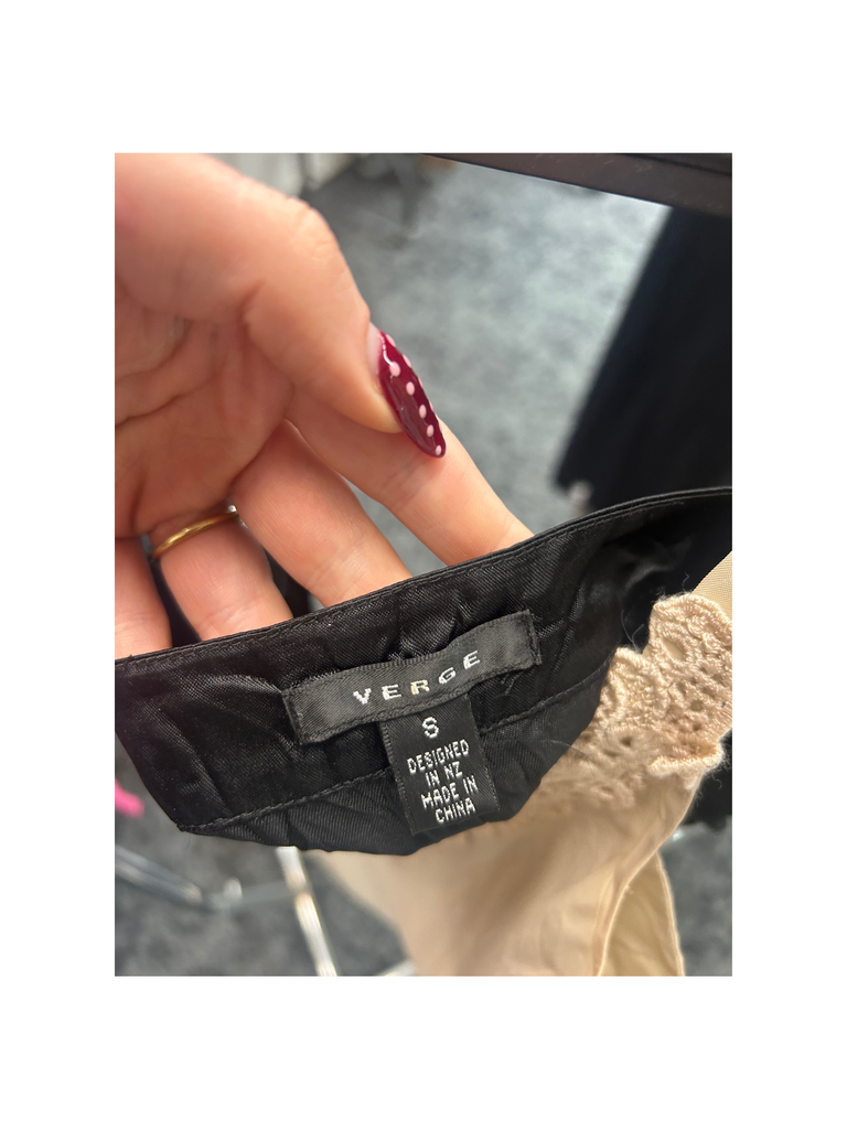 Closeup of the brand label of a Vintage VERGE Cami in Navy Blue with Bead embellishment